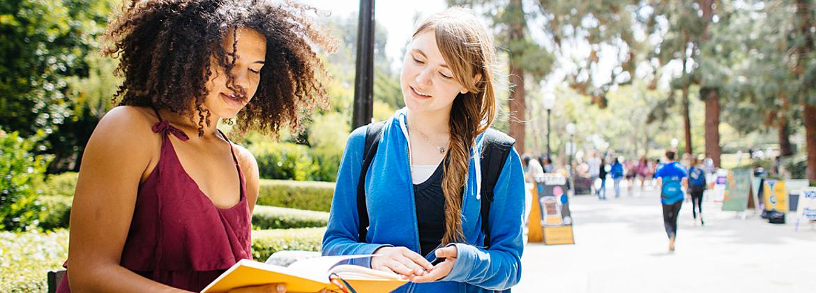 Two students looking at a book