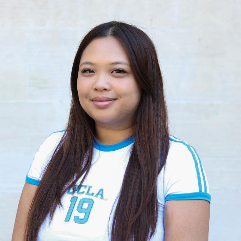 UCLA student wearing a blue and white shirt with a white background
