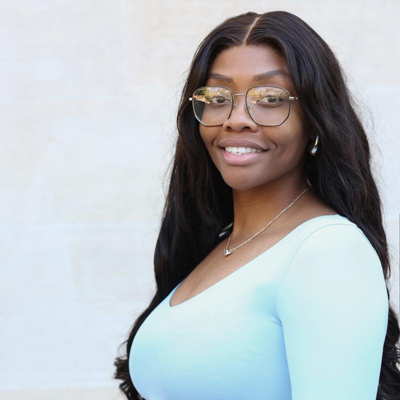 UCLA student wearing a blue shirt with a white background