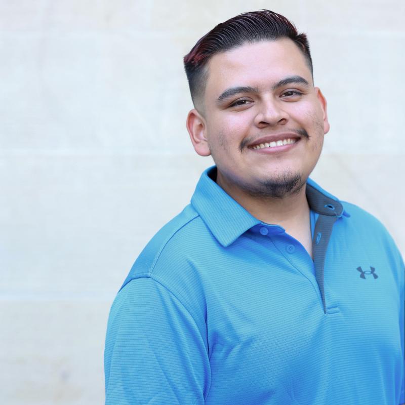 UCLA student wearing a blue shirt with a white background